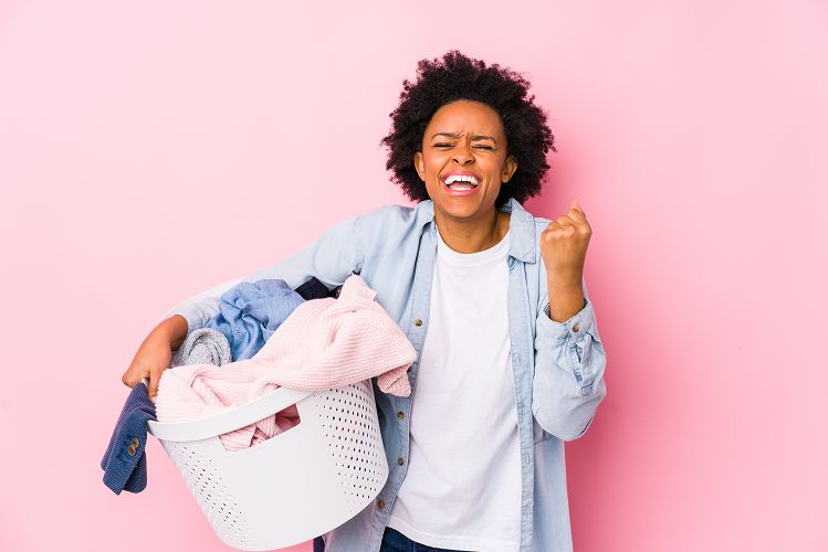 Woman celebrating with a basket of laundry